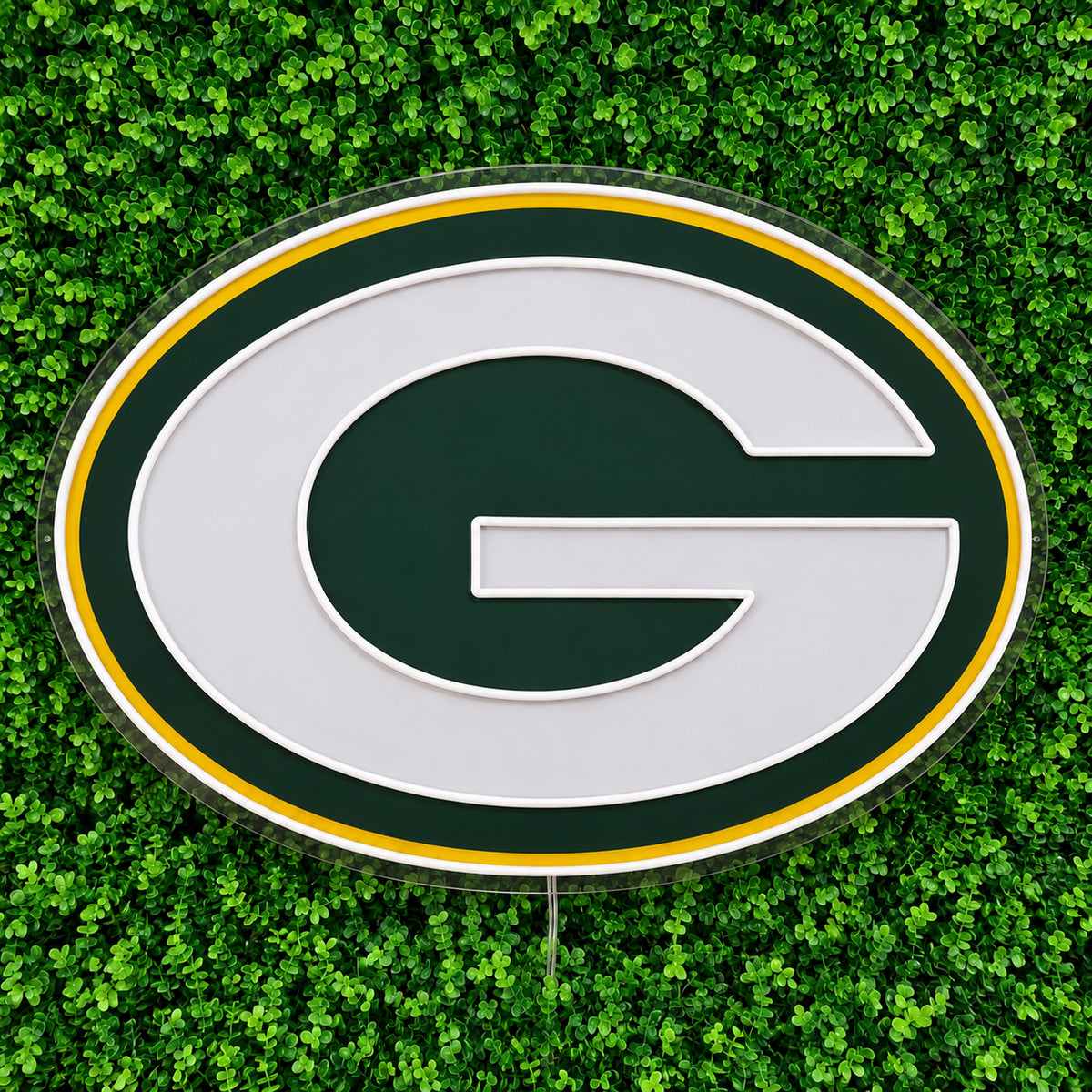 Green Bay Packers LED Neon Sign, featuring illuminated team logo on a green foliage wall.