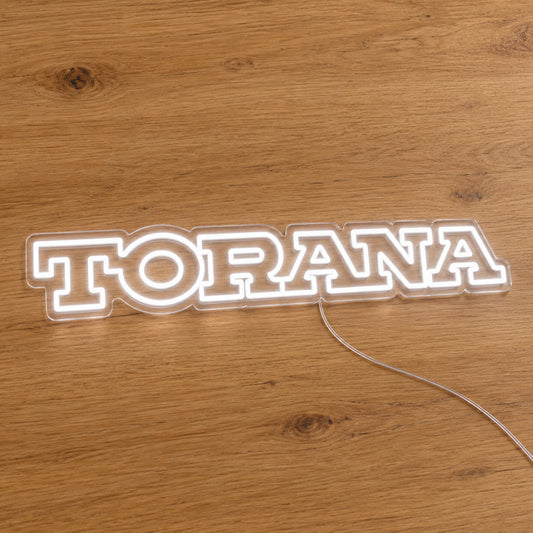 Holden Torana LED Neon Sign in white, featuring Torana lettering on a wooden surface.