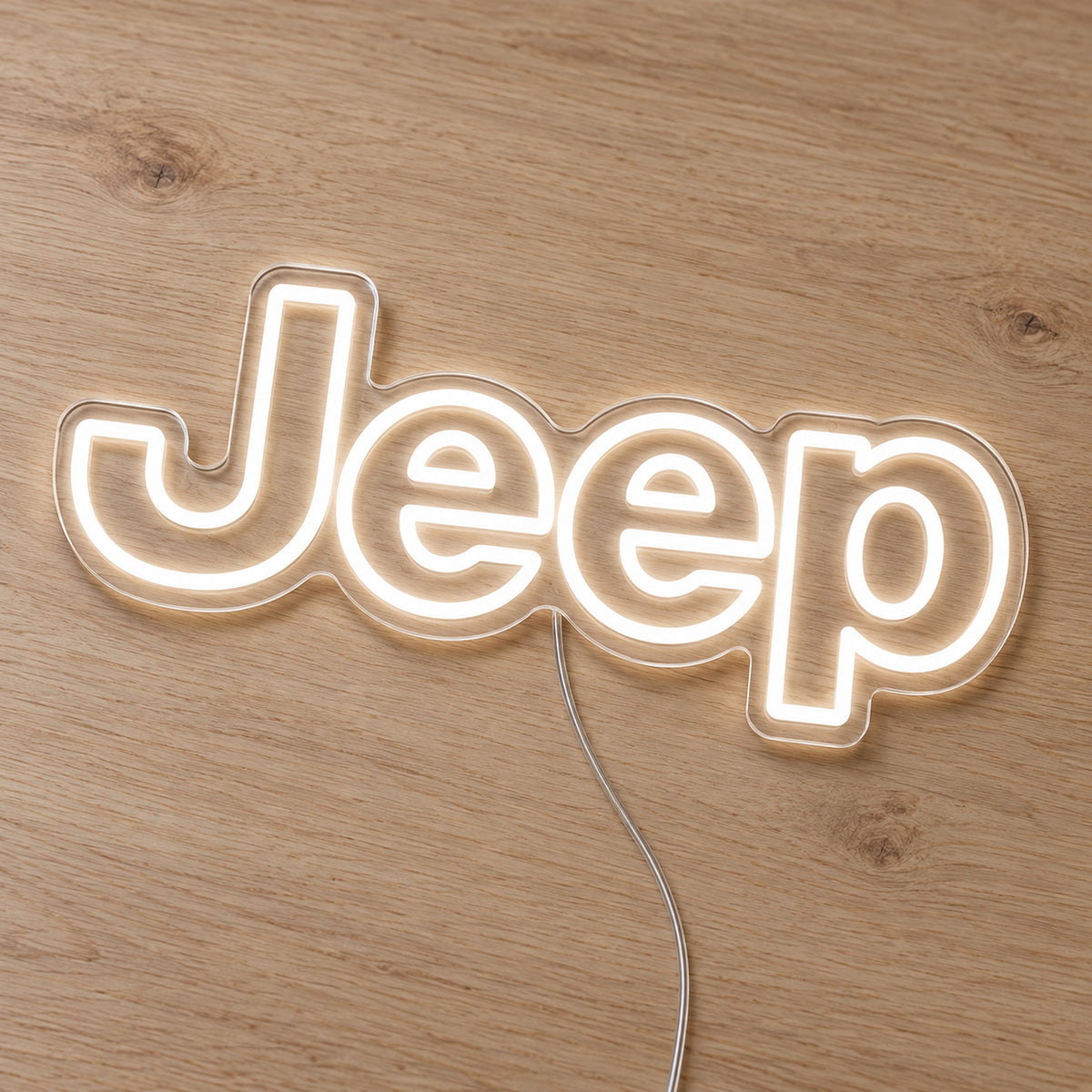 Jeep LED Neon Sign, featuring illuminated vehicle logo on a wooden surface.