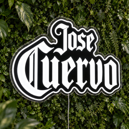 Jose Cuervo LED Neon Sign, featuring illuminated brand logo on a green foliage wall.