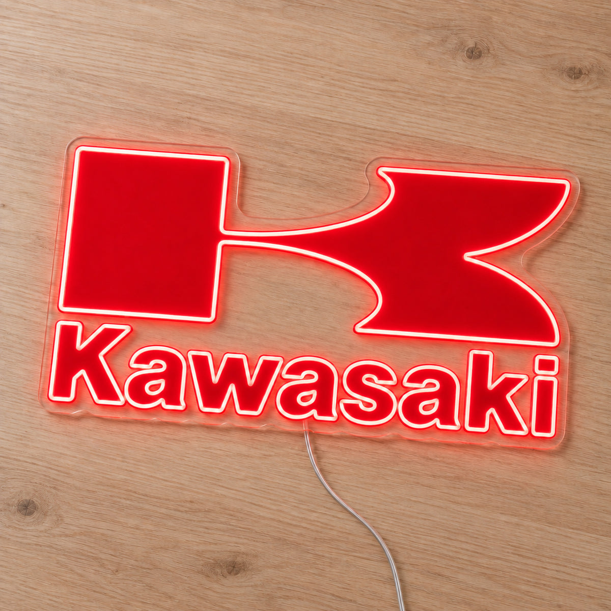 Kawasaki LED Neon Sign, featuring illuminated vehicle logo on a wooden surface.