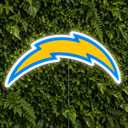 LA Chargers LED Neon Sign, featuring illuminated team logo on a green foliage wall.