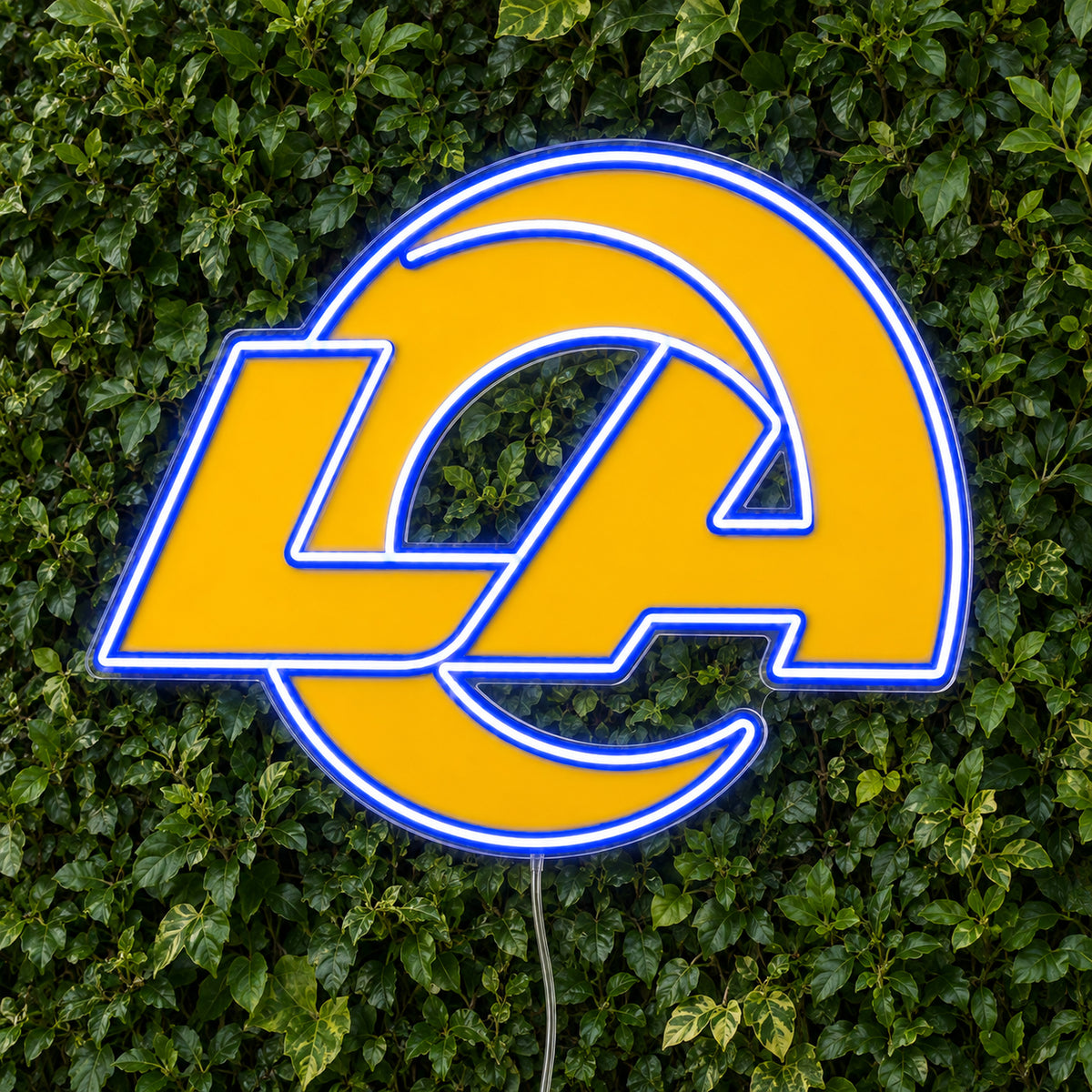 LA Rams LED Neon Sign, featuring illuminated team logo on a green foliage wall.