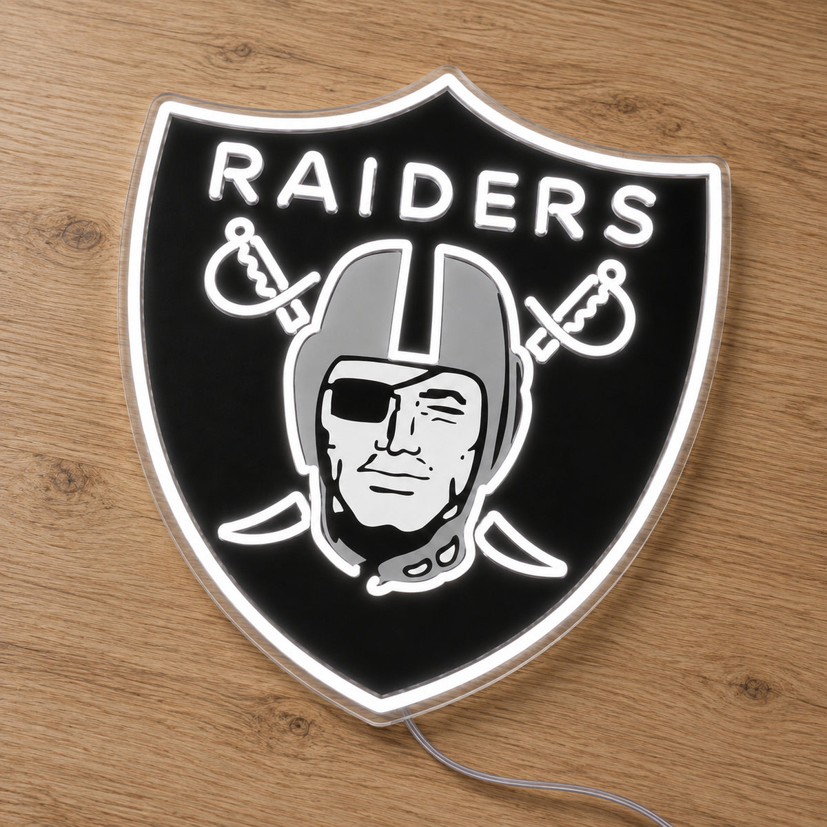 Las Vegas Raiders LED Neon Sign, featuring illuminated team logo on a wooden surface.