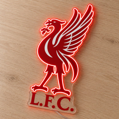 Liverpool LED Neon Sign, featuring team logo displayed on a wooden surface.