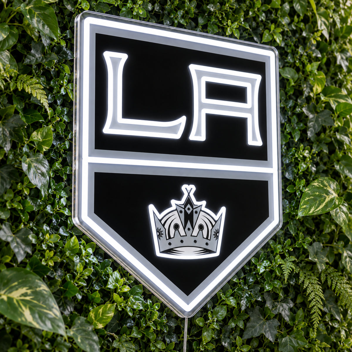 Los Angeles Kings LED Neon Sign, featuring team logo displayed on a green foliage wall.