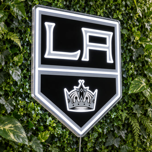 Los Angeles Kings LED Neon Sign, featuring team logo displayed on a green foliage wall.