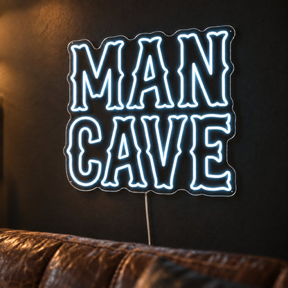 Man Cave LED Neon Sign in white, featuring two lines of rustic Man Cave lettering above a leather sofa.