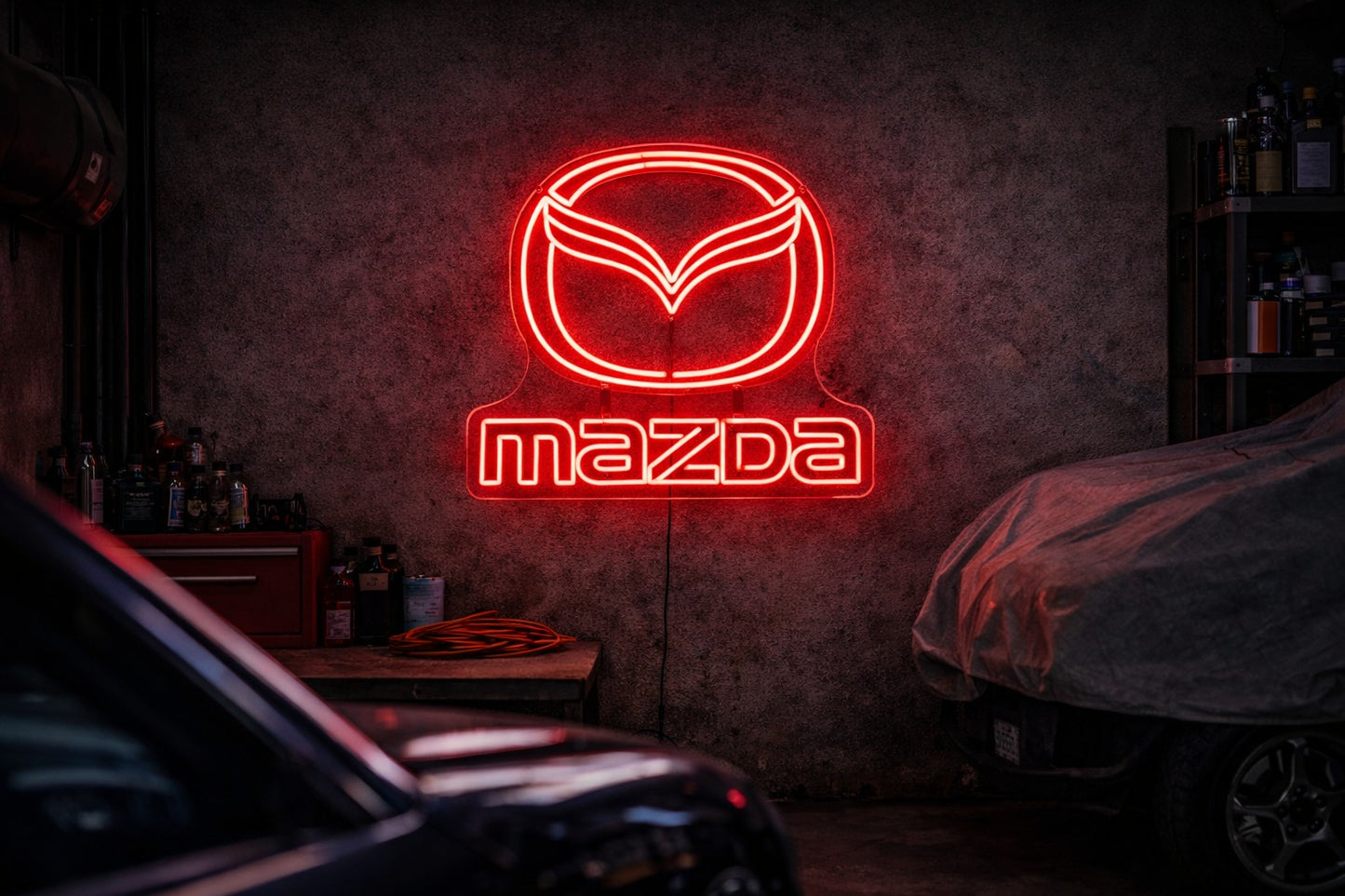 Mazda logo LED neon sign mounted in a modern garage, clean automotive wall light
