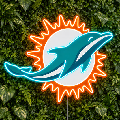 Miami Dolphins LED Neon Sign, featuring illuminated team logo on a green foliage wall.