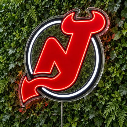 New Jersey Devils LED Neon Sign, featuring team logo displayed on a green foliage wall.
