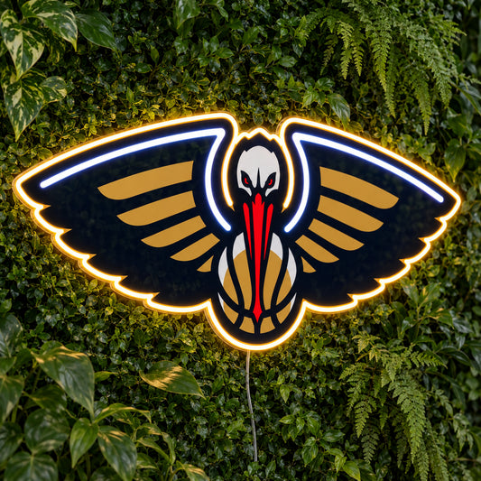 New Orleans Pelicans LED Neon Sign, featuring illuminated team logo on a green foliage wall.