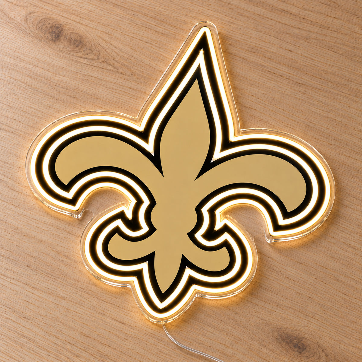 New Orleans Saints LED Neon Sign, featuring team logo displayed on a wooden surface.