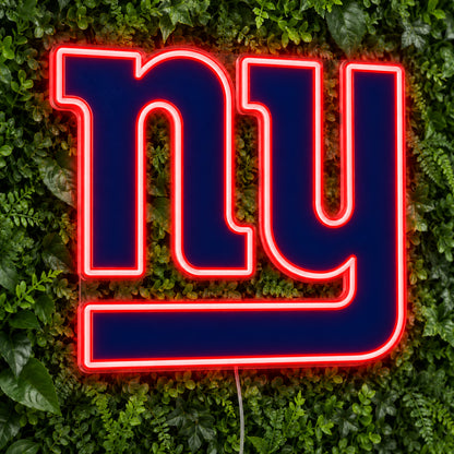 New York Giants LED Neon Sign, featuring illuminated team logo on a green foliage wall.