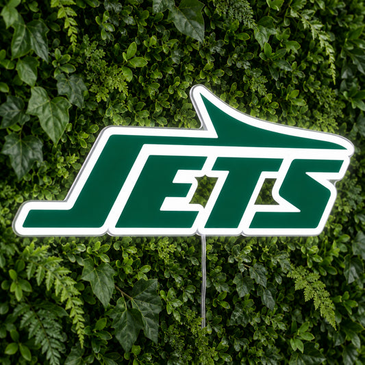 New York Jets LED Neon Sign, featuring illuminated team logo on a green foliage wall.