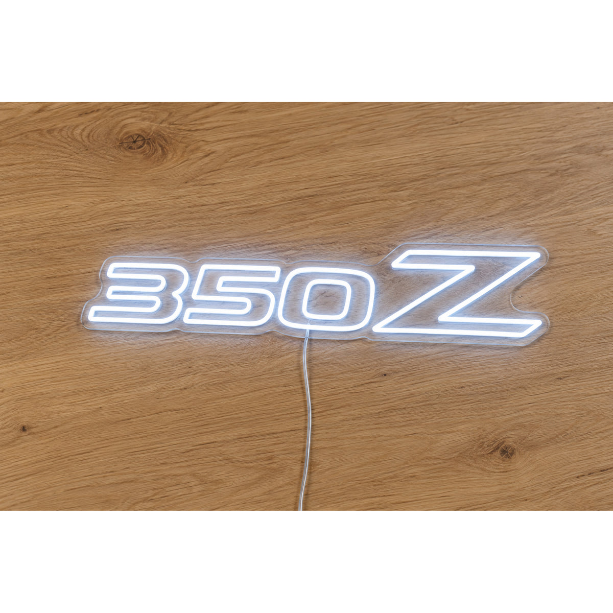 Nissan 350Z LED Neon Sign in white, featuring 350Z lettering on a wooden surface.
