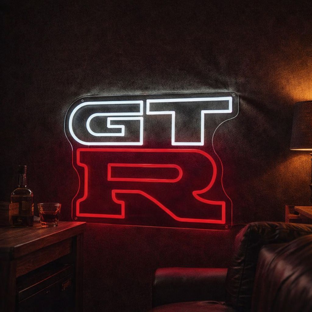 Nissan GTR logo LED neon sign mounted in a performance garage setting