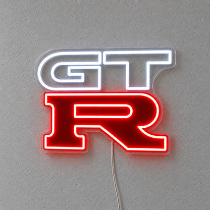 Nissan GTR LED Neon Sign in white and red, featuring GT-R logo on a grey wall.
