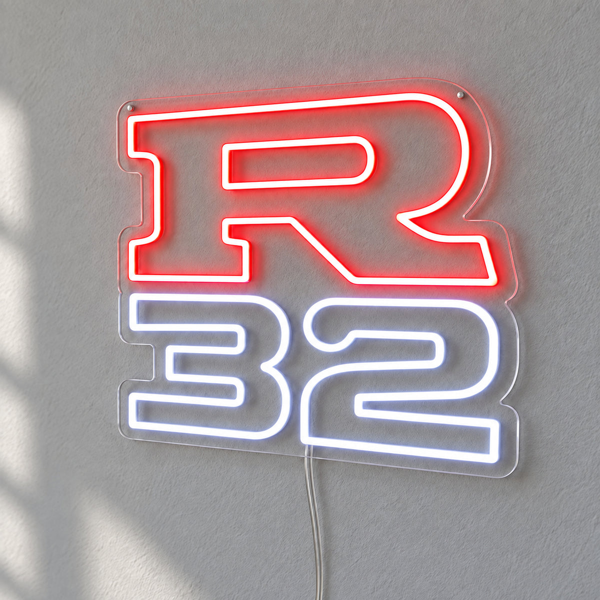 Nissan R32 LED Neon Sign in red and white, featuring R32 lettering on a grey wall.