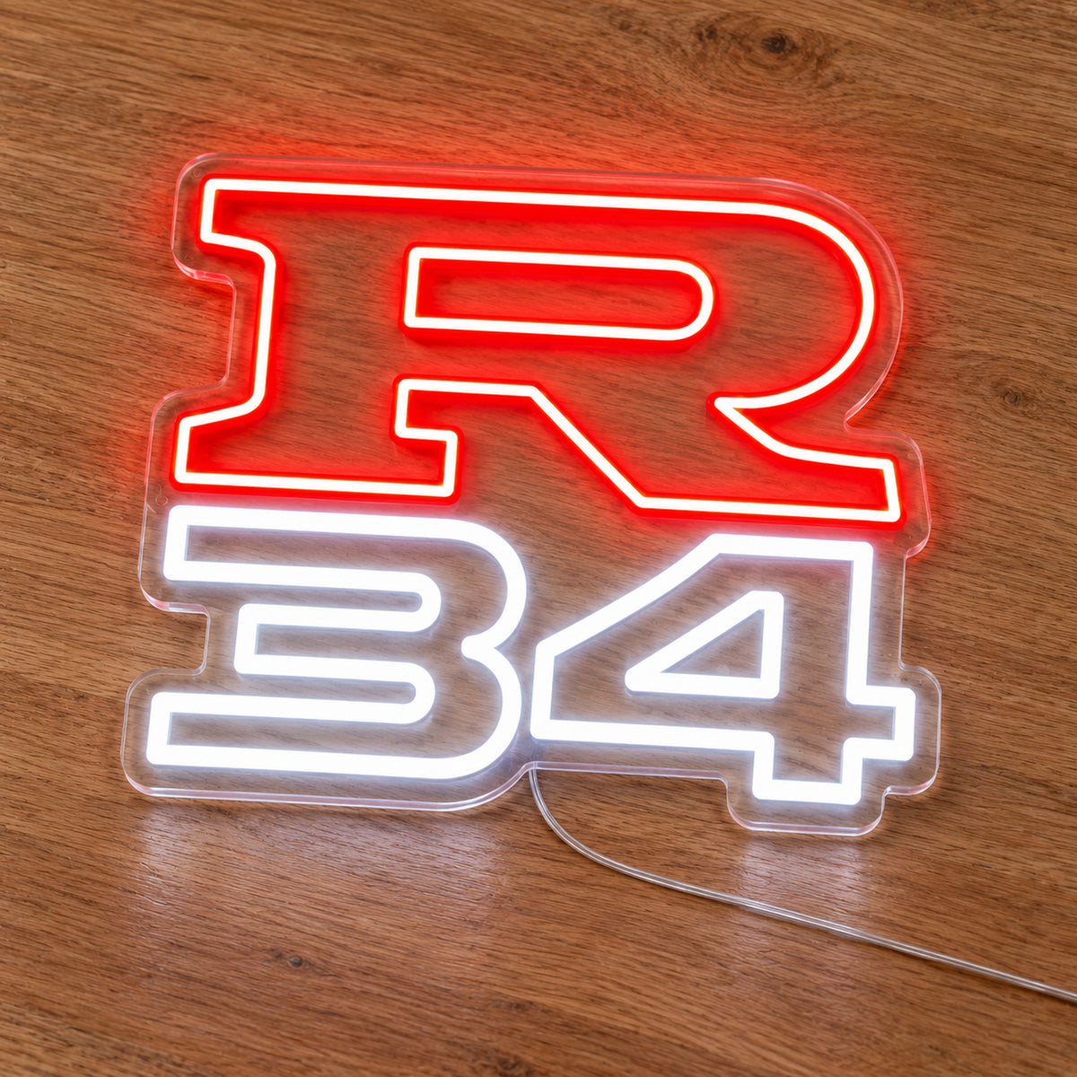 Nissan R34 LED Neon Sign in red and white, featuring R34 lettering on a wooden surface.