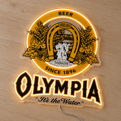 Olympia LED Neon Sign, featuring beer-brand logo displayed on a wooden surface.