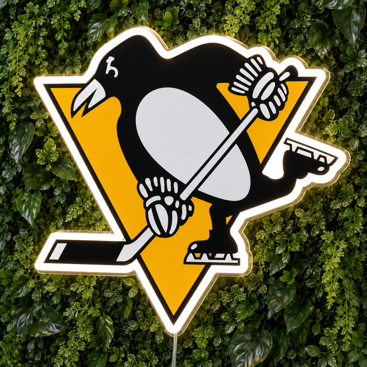 Pittsburgh Penguins LED Neon Sign, featuring team logo displayed on a green foliage wall.