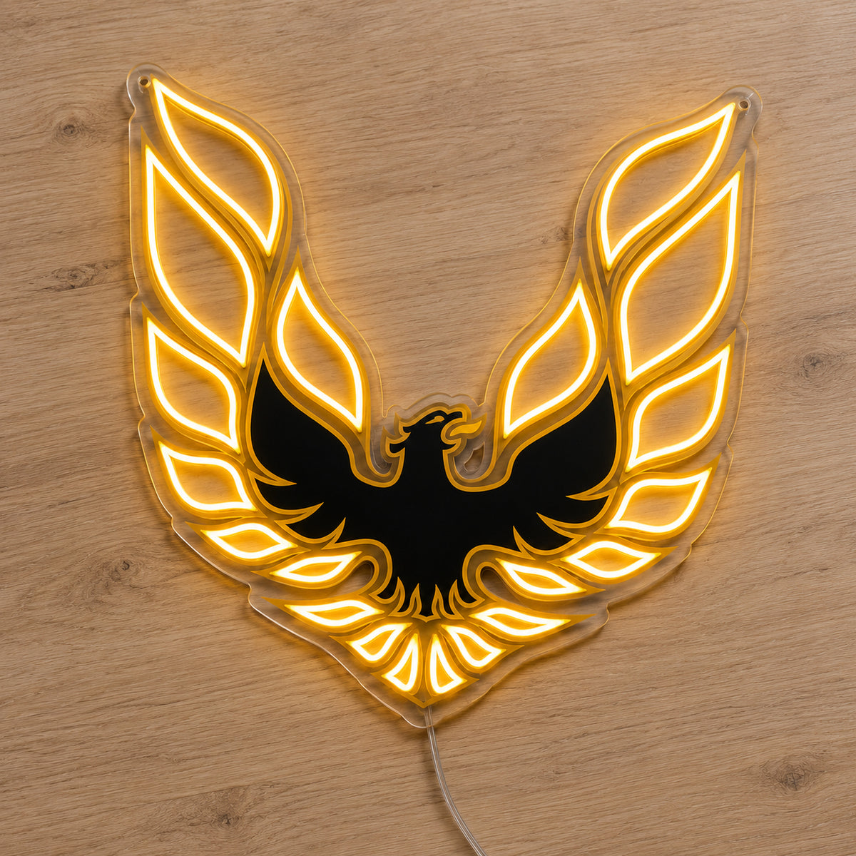 Pontiac Firebird LED Neon Sign, featuring illuminated vehicle logo on a wooden surface.