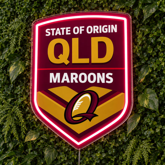 Queensland Maroons State of Origin LED Neon Sign, featuring illuminated team logo on a green foliage wall.