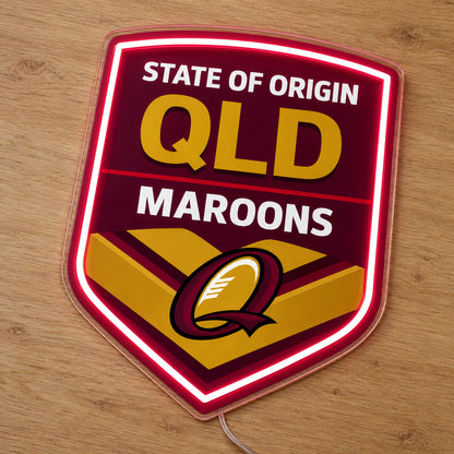 Queensland Maroons State of Origin LED Neon Sign, featuring illuminated team logo on a wooden surface.