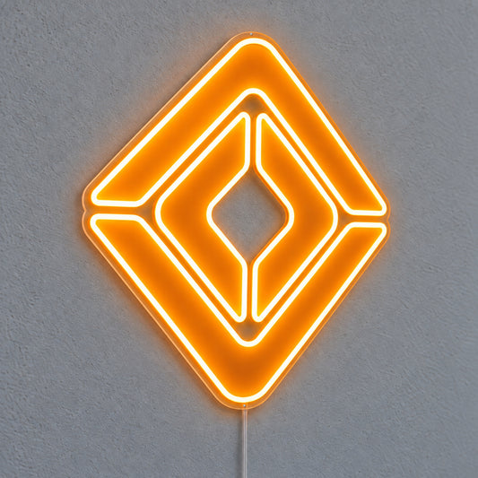 Renault neon sign with an orange diamond emblem on clear acrylic, illuminated against a grey wall.