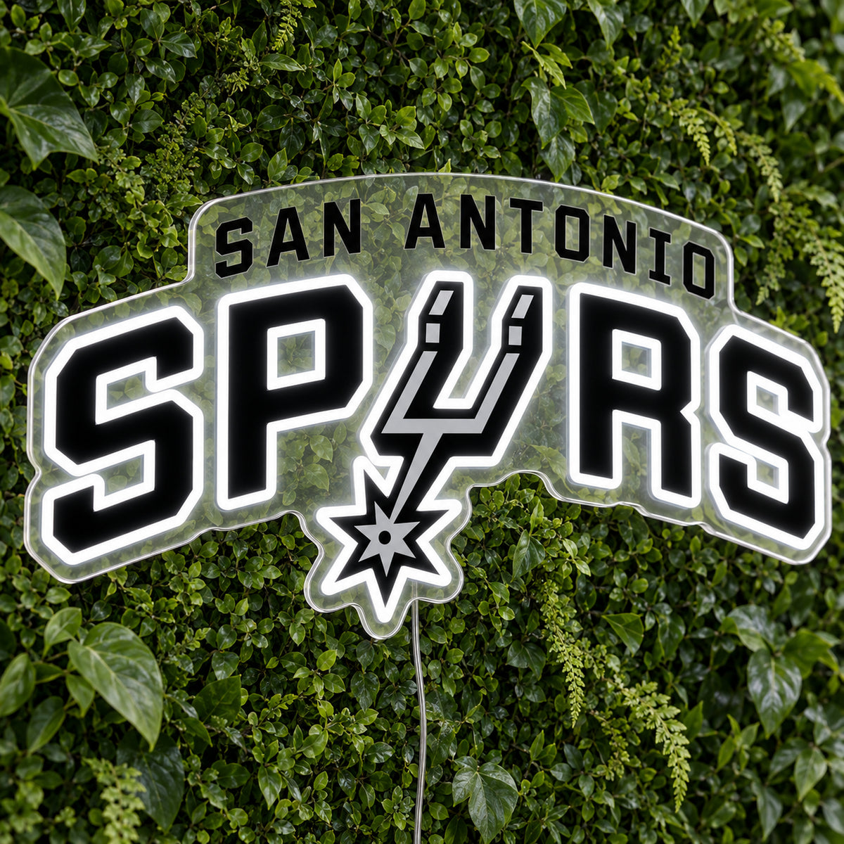 San Antonio Spurs LED Neon Sign, featuring illuminated team logo on a green foliage wall.