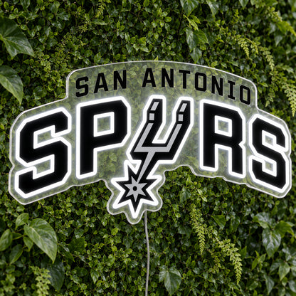 San Antonio Spurs LED Neon Sign, featuring illuminated team logo on a green foliage wall.