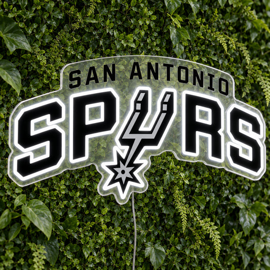 San Antonio Spurs LED Neon Sign, featuring illuminated team logo on a green foliage wall.
