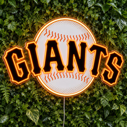 San Francisco Giants LED Neon Sign, featuring illuminated team logo on a green foliage wall.