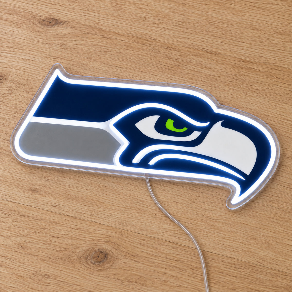 Seattle Seahawks LED Neon Sign, featuring illuminated team logo on a wooden surface.