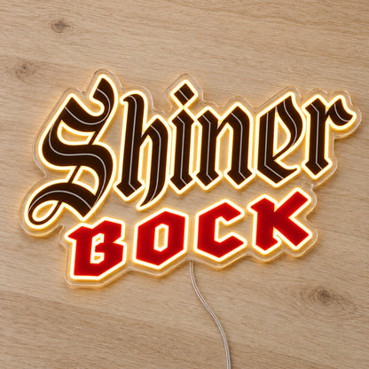 Shiner Bock LED Neon Sign, featuring illuminated beer-brand logo on a wooden surface.