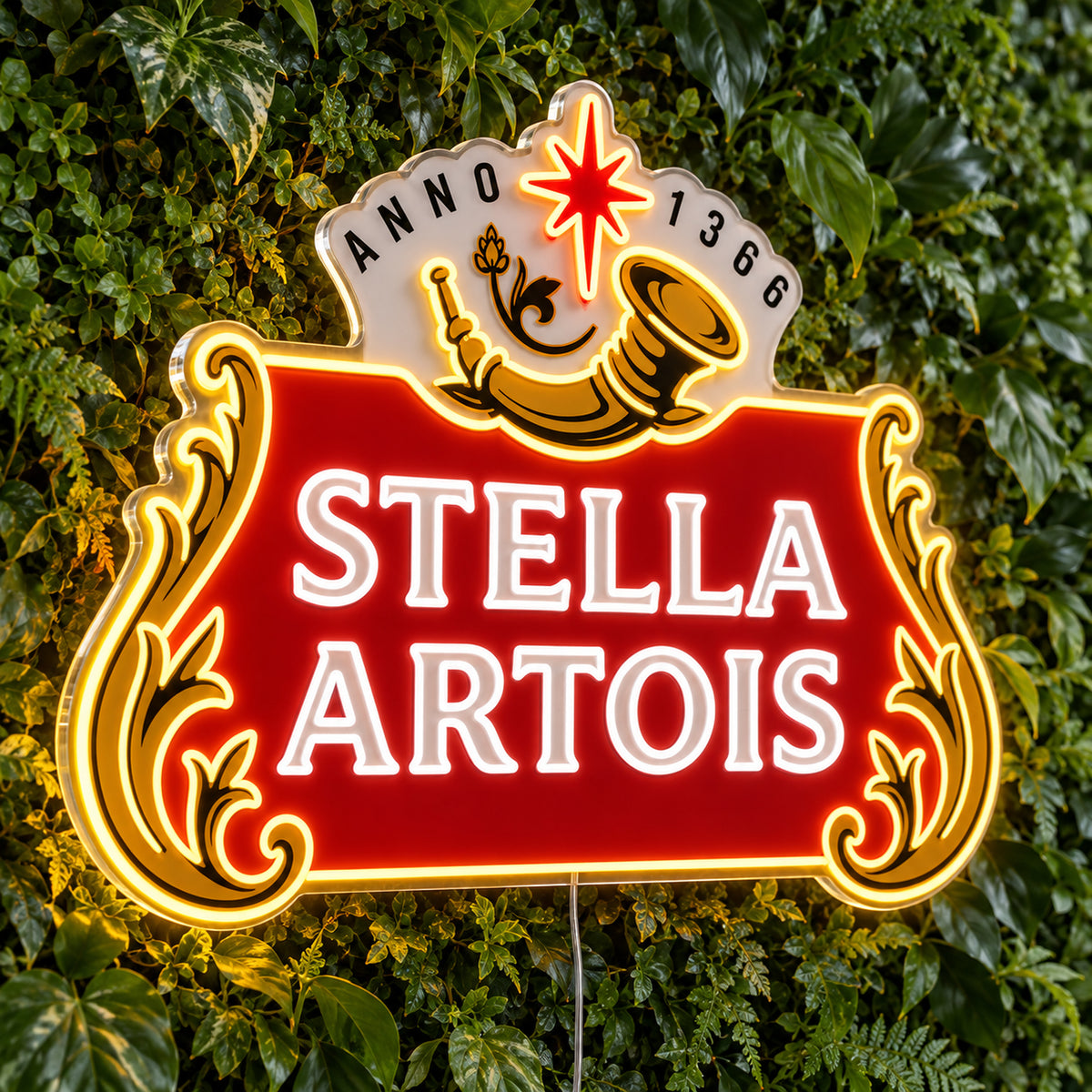 Stella Artois LED Neon Sign, featuring beer-brand logo displayed on a green foliage wall.