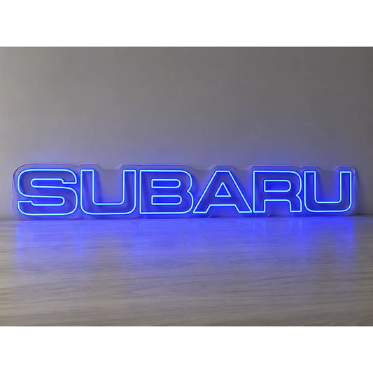 Subaru Logo LED Neon Sign in blue, featuring Subaru lettering on a light surface.
