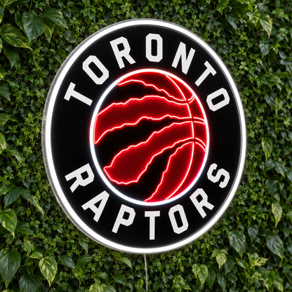 Toronto Raptors LED Neon Sign, featuring illuminated team logo on a green foliage wall.