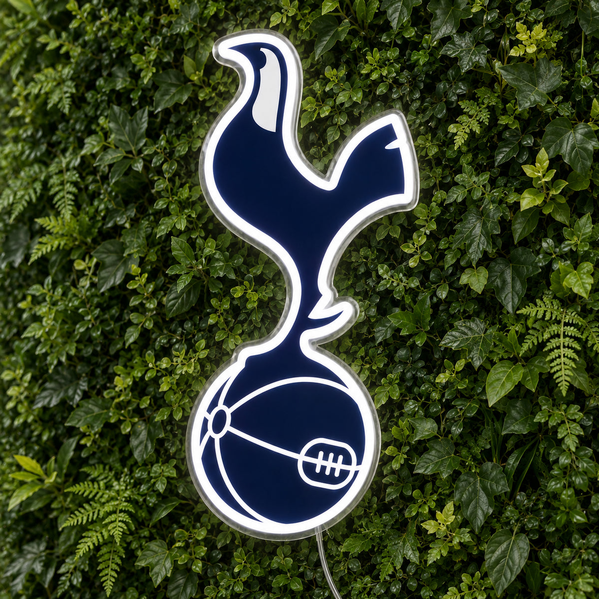 Tottenham LED Neon Sign, featuring team logo displayed on a green foliage wall.