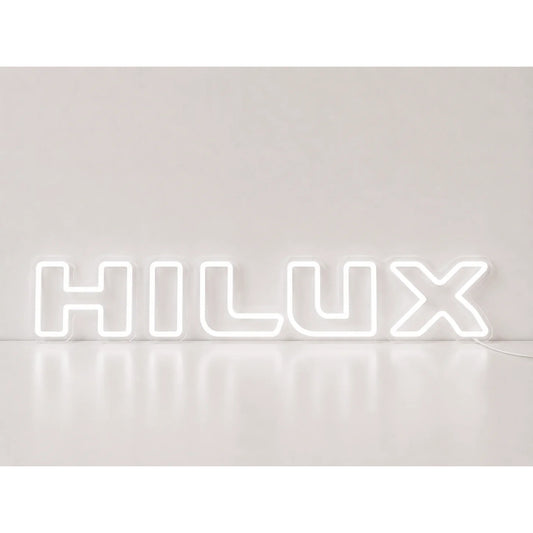 Toyota Hilux Neon Sign in white, featuring Hilux lettering on a light wall.