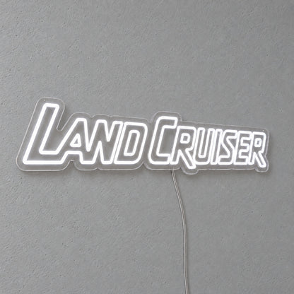 Toyota Land Cruiser LED Neon Sign in white, featuring Land Cruiser lettering on a grey wall.