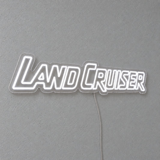 Toyota Land Cruiser LED Neon Sign in white, featuring Land Cruiser lettering on a grey wall.