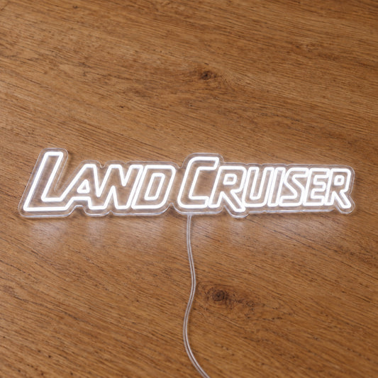 Toyota Land Cruiser LED Neon Sign in white, featuring Land Cruiser lettering on a wooden surface.