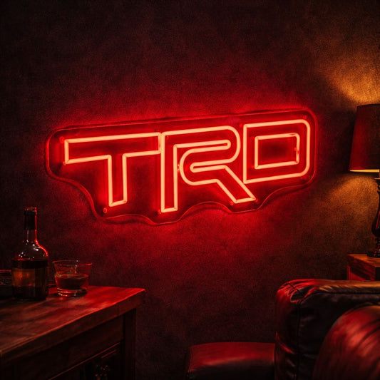 Toyota TRD LED neon sign glowing on a garage wall, bold performance badge neon light