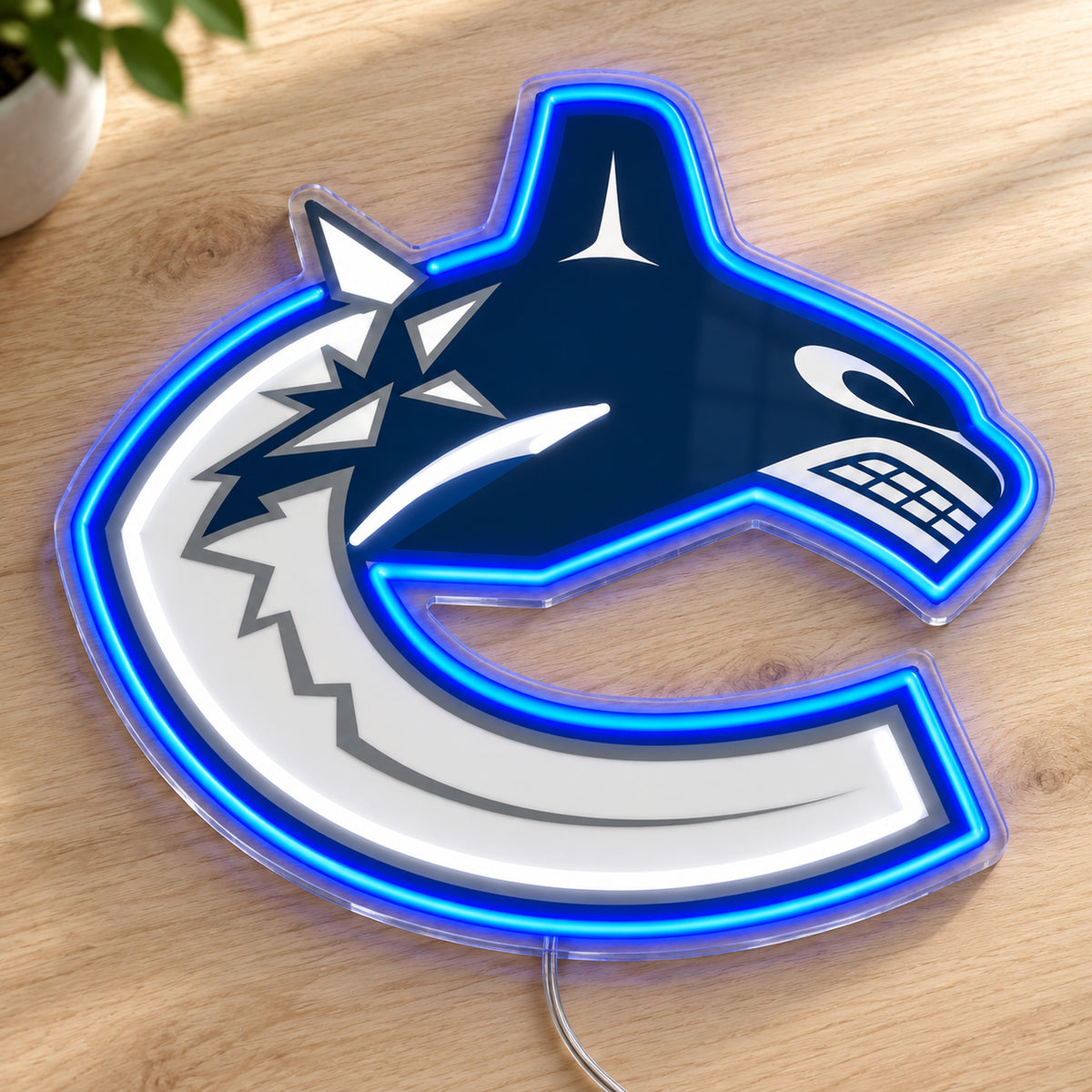Vancouver Canucks LED Neon Sign, featuring team logo displayed on a wooden surface.