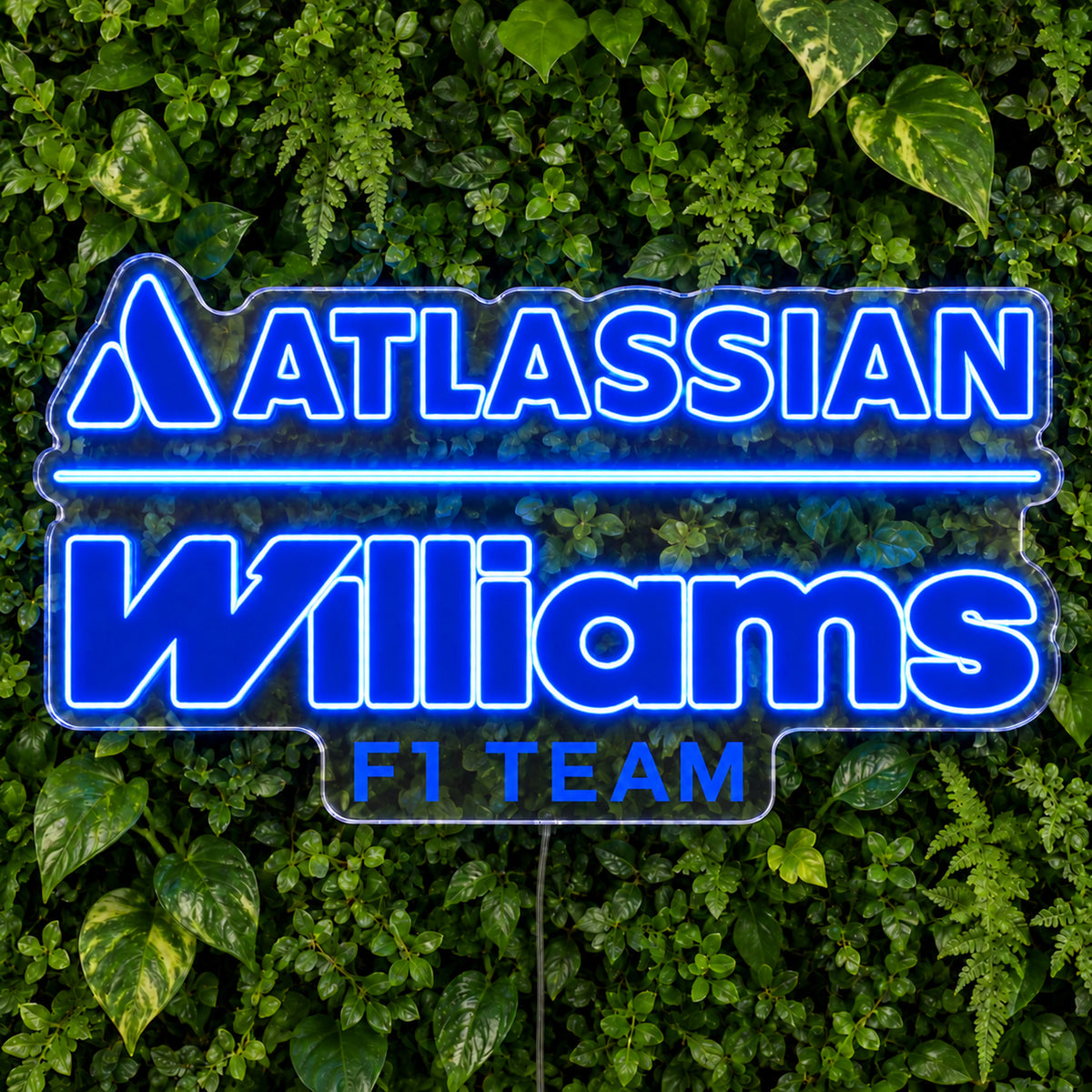 Williams F1 LED Neon Sign, featuring team logo displayed on a green foliage wall.