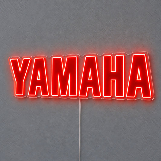Yamaha (Red) LED Neon Sign in red, featuring Yamaha lettering on a grey wall.