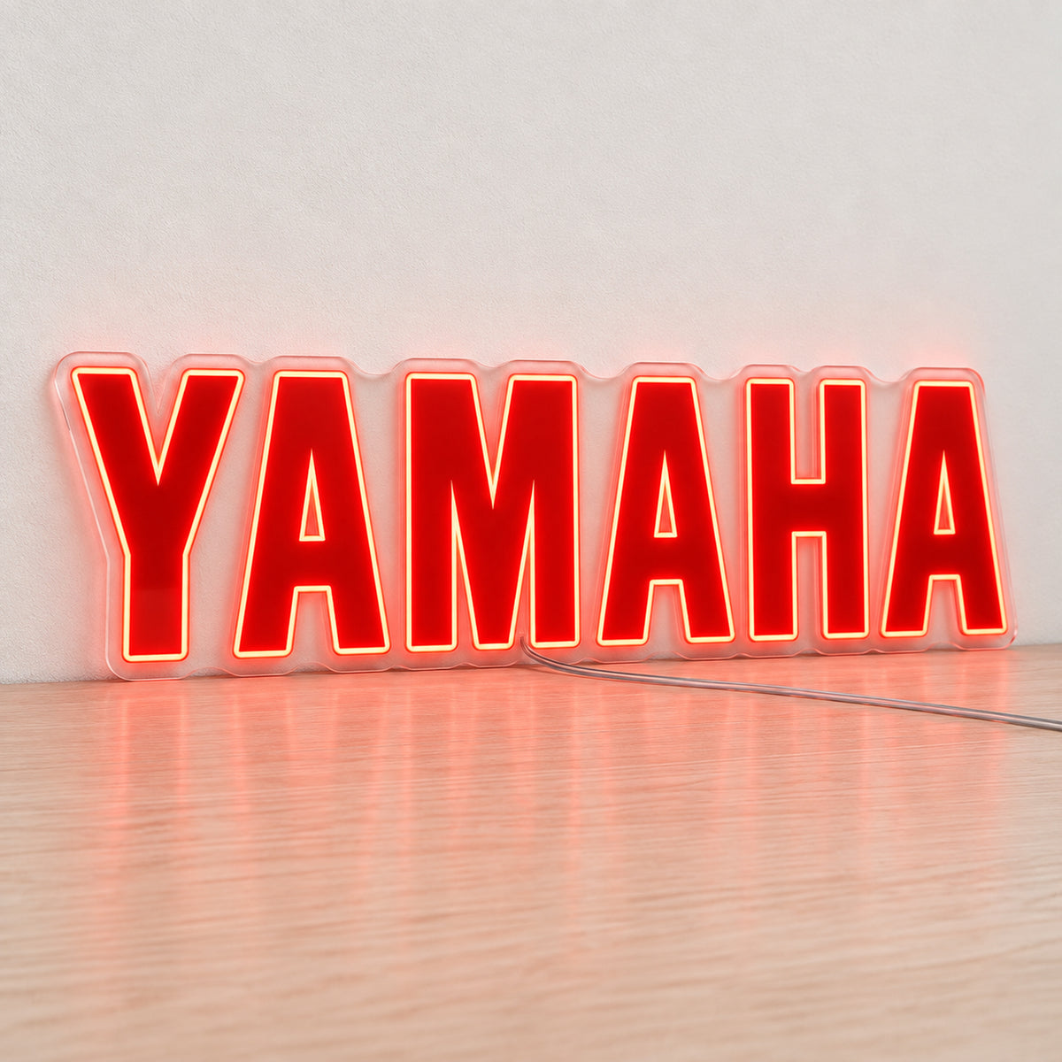 Yamaha (Red) LED Neon Sign in red, featuring Yamaha lettering on a light reflective surface.