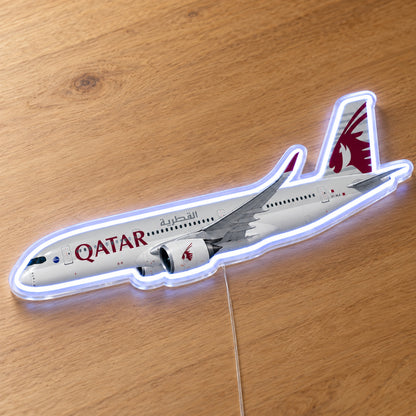 Airbus A350-900 Qatar Airways Neon Sign with printed aircraft details and an illuminated LED outline on clear acrylic, shown on a wooden surface, registration A7-ALA